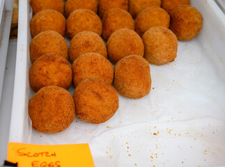 Traditional street food in UK, stuffed fried Scotch eggs with breadcrumbs