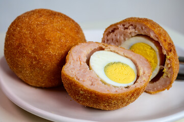 Traditional street food in UK, stuffed fried Scotch eggs with breadcrumbs
