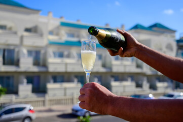 Dinner party, drinking of cava or champagne sparkling wine in vacation resort Caleta Fuste, Fuerteventura, Canary islands vacation, Spain