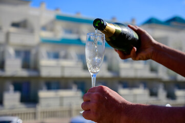 Dinner party, drinking of cava or champagne sparkling wine in vacation resort Caleta Fuste, Fuerteventura, Canary islands vacation, Spain