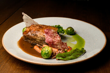 great view on dish of piece of baked meat with buckwheat and vegetables on plate