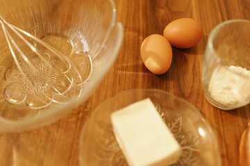 Detail shot of eggs, flour and margarine. Warm tones.