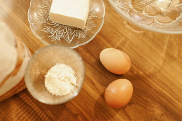 Detail shot of eggs, flour and margarine. Warm tones.