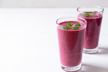 Tasty blueberry smoothie in glass on white background