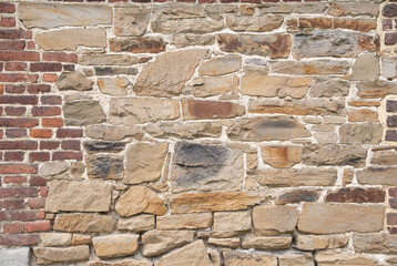 texture of rough masonry yellow rough bricks and cement between them, stone wall