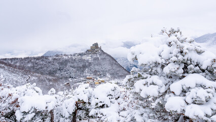 Image of the Ancient/ Abbey of San Michele built on Mount Pirchiriano located at the entrance of the Susa Valley, around the years between 983 and 987 A.D. with an abundant snowfall