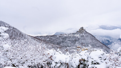 Image of the Ancient/ Abbey of San Michele built on Mount Pirchiriano located at the entrance of the Susa Valley, around the years between 983 and 987 A.D. with an abundant snowfall