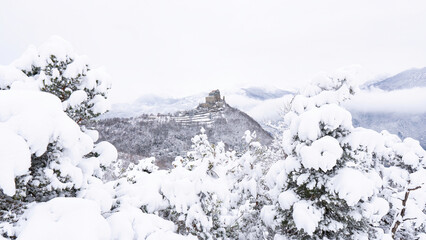 Image of the Ancient/ Abbey of San Michele built on Mount Pirchiriano located at the entrance of the Susa Valley, around the years between 983 and 987 A.D. with an abundant snowfall