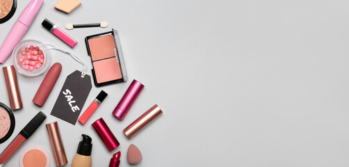 Set of makeup cosmetics and accessories for sale on grey background with space for text