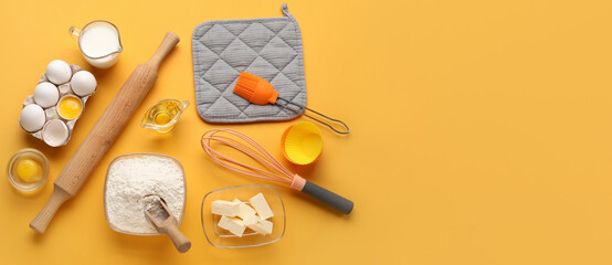 Different ingredients and utensils for baking on orange background with space for text