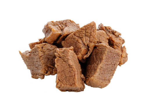 Pieces of cooked beef meat are isolated on a white background. 