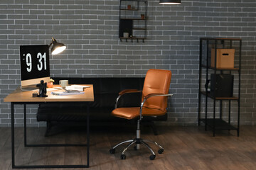 Interior of dark office with accountant's workplace and glowing lamps