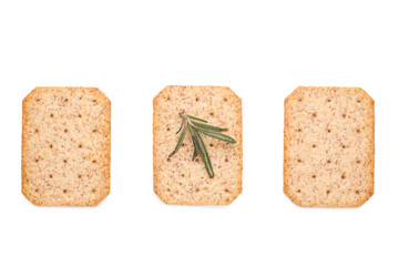 Tasty crackers and rosemary isolated on white background