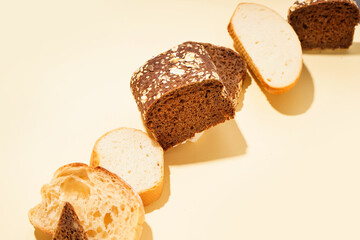 Slices of different bread on yellow background