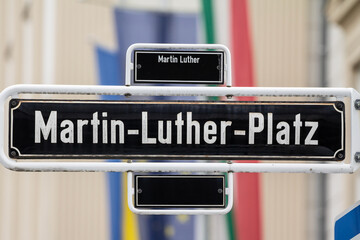 Selective blur on a street sign indicating Martin Luther Platz square, one of the main squares of...