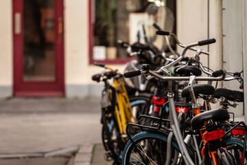 Selective blur on plenty of bicycles, parked in a crowd, in the city center of Maastricht, netherlands, known for being car free and pedestrian. Cycling and bikes are a symbol of netherlands.
