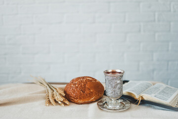 Wine, bread and open bible, communion concept