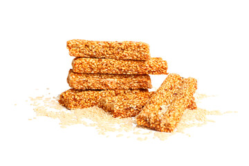 Tasty kozinaki and sesame seeds isolated on white background