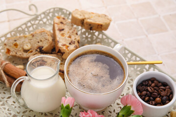 Tray with delicious biscotti cookies, cup of coffee, eustoma flowers and beans, closeup