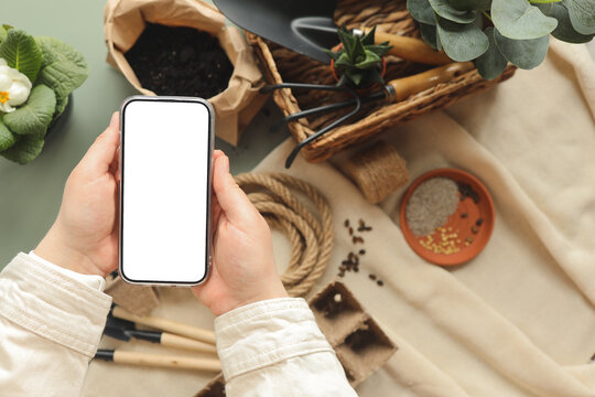 Phone with an isolated screen for your text on the background of garden tools