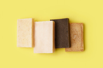 Set of natural soap bars on yellow background