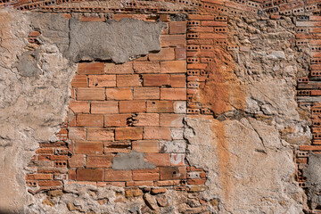 Crumbled brick and stucco on an old wall
