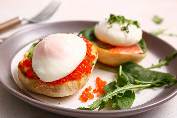 Plate with tasty eggs Benedict on white table, closeup