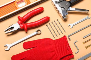 Composition with different construction tools on beige background