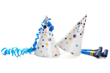 Party hats with serpentine and whistles on white background