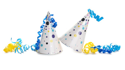 Party cone hats with serpentine on white background