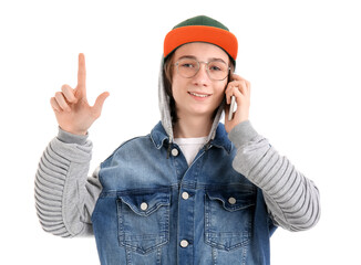 Cool teenage boy talking by mobile phone on white background