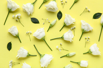 Composition with beautiful eustoma and gypsophila flowers on yellow background