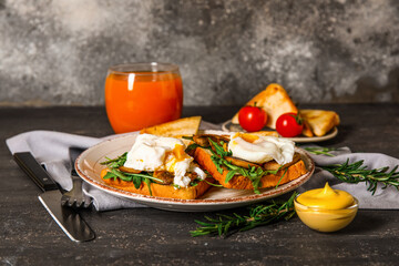 Plate with tasty eggs Benedict on table