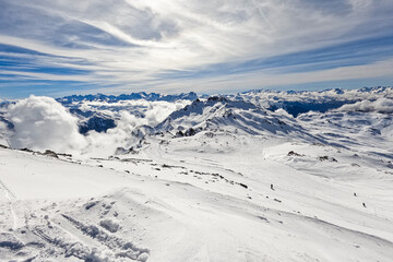 View of the French Alps in winter from the summit of "Cime de Caron" - Snowy peaks in altitude, covered by ski slopes