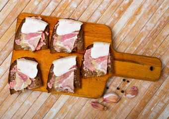 Appetizing sandwiches made of lard with horseradish on black bread
