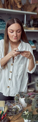 Young caucasian happy seller woman at botanic shop