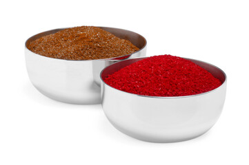 Bowls with food coloring on white background