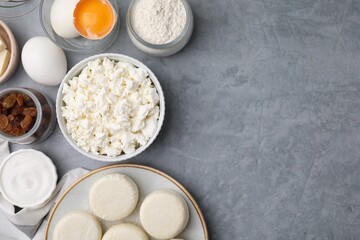 Uncooked cottage cheese pancakes and different ingredients on light grey table, flat lay. Space for text