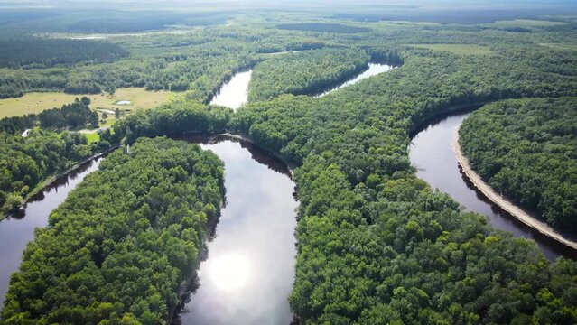 Flying over a very winding river and forest in Northern Minnesota near the border of Canada