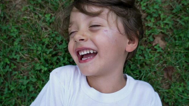Portrait of a happy child laughing and smiling. Real life authentic kid laugh and smile. Tickling Close up face of young boy