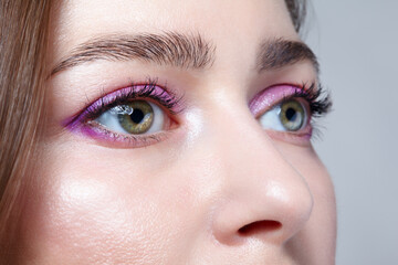 Closeup shot of human female face with pink makeup.