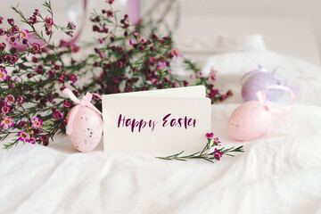 Easter eggs with flowers on white linen fabric. Spring and Easter concept.