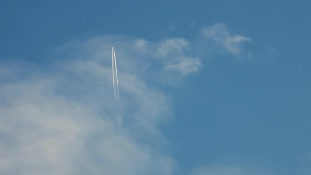 a passenger plane flying through the clouds, Viewed from below in nadir shot.
