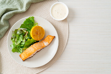 fried salmon steak with lemon and vegetable