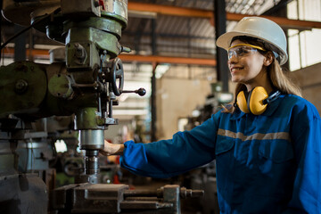 female mechanical engineer working on industrial factory machinery