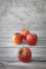 A red rotten disgusting apple separated of good ones. Bad and good separated.