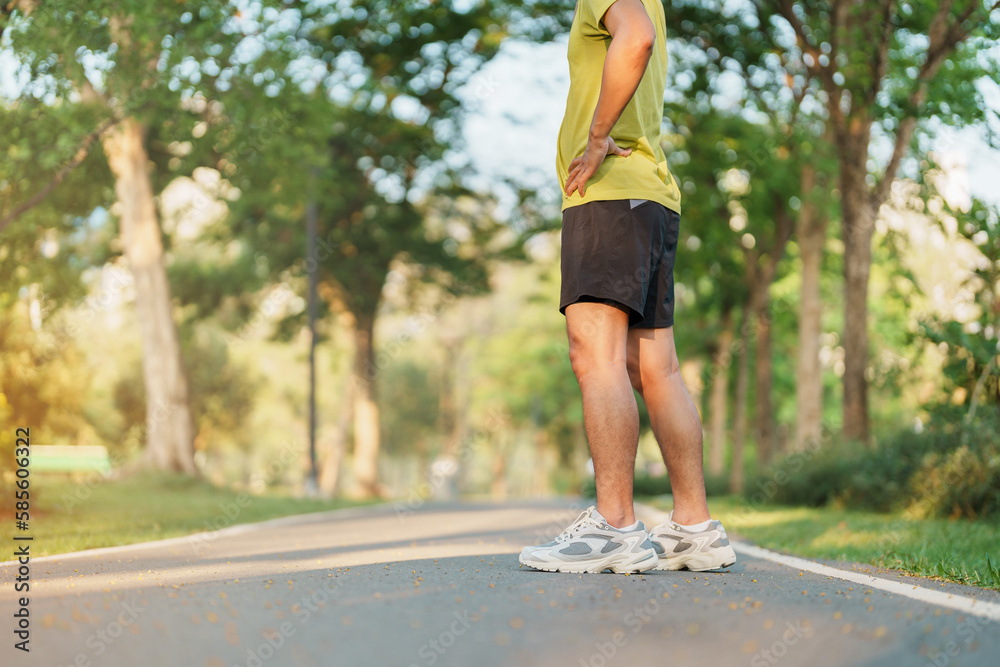 Wall mural man jogging and walking on the road at morning, adult male in sport shoes running in the park outside. Exercise, wellness, healthy lifestyle and wellbeing concepts