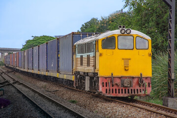 Fototapeta na wymiar Container-freight train by diesel locomotive on the railway.
