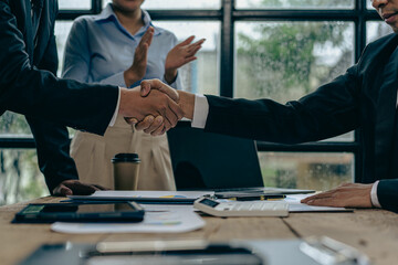 Two confident businessmen shaking hands during meeting in office Successful collaboration and contact Greetings and Partnerships in the Real Estate Business
