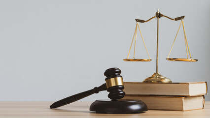 Law and justice concept. Mallet of the judge, scales and stack books with copyspace.